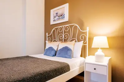 a bedroom with a bed and a nightstand with a lamp at Upscale Apartments w Balcony - Near Istiklal in Istanbul