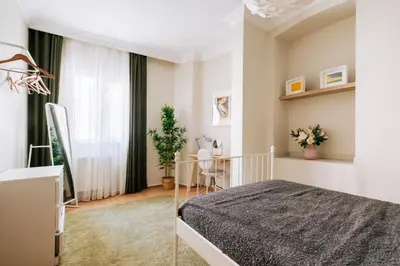 a bedroom with a bed and a table and a window at Upscale Apartments w Balcony - Near Istiklal in Istanbul