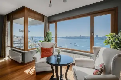 a living room with a view of the water at Duplex Flat w Panoramic Bosphorus View and Terrace in Istanbul