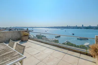 a balcony with a view of the water at Duplex Flat w Panoramic Bosphorus View and Terrace in Istanbul