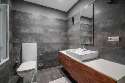 a bathroom with a sink and a toilet and a mirror at Duplex Flat w Panoramic Bosphorus View and Terrace in Istanbul