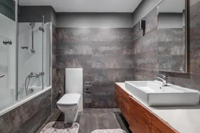 a bathroom with a sink and a toilet and a shower at Duplex Flat w Panoramic Bosphorus View and Terrace in Istanbul