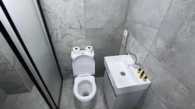 a bathroom with a white toilet and a sink at Matrushka Hotel Apart in Istanbul