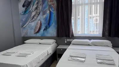 two beds in a room with towels on them at Matrushka Hotel Apart in Istanbul