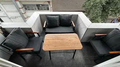 a patio with two chairs and a table on a balcony at Tuzla Sahil Enjoy Hotel in Tuzla