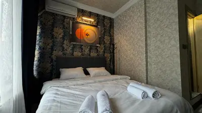 a bedroom with a bed with towels on it at Tuzla Sahil Enjoy Hotel in Tuzla