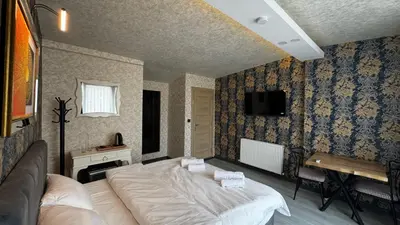a bedroom with a large bed and a desk at Tuzla Sahil Enjoy Hotel in Tuzla