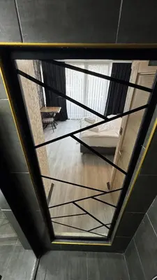 a glass staircase in a room with a table at Tuzla Sahil Enjoy Hotel in Tuzla