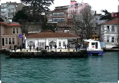 a boat is docked at a dock in the water at An İstanbul tale, İstanbul dream,bosphorus villa in Istanbul