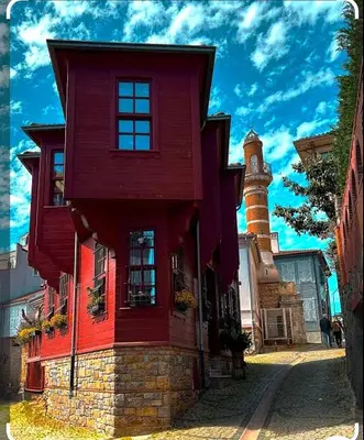 a red house with a lighthouse on a street at An İstanbul tale, İstanbul dream,bosphorus villa in Istanbul