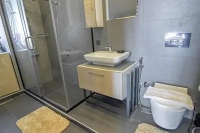 a bathroom with a sink and a shower and a toilet at Modern 2BR Flat 1min walk to Taksim square in Istanbul