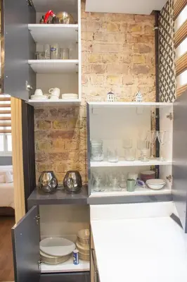 a cupboard with plates and dishes in it at Modern 2BR Flat 1min walk to Taksim square in Istanbul