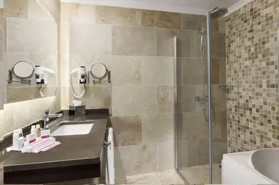 a bathroom with a sink and a shower at Ramada by Wyndham Istanbul Merter in Istanbul