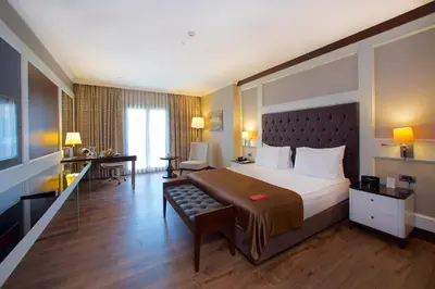 a hotel room with a large bed and a desk at Ramada by Wyndham Istanbul Merter in Istanbul