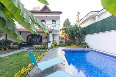 a villa with a swimming pool and a house at 4BR all AC Pool BBQ Garden on Bagdat Ave Kirkpinar in Sapanca