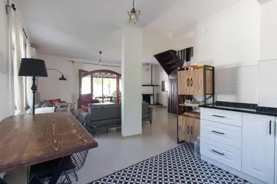 a kitchen and living room with a table and a dining room at 4BR all AC Pool BBQ Garden on Bagdat Ave Kirkpinar in Sapanca