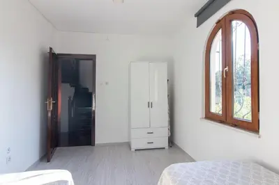 a bedroom with a bed and a mirror on the wall at 4BR all AC Pool BBQ Garden on Bagdat Ave Kirkpinar in Sapanca