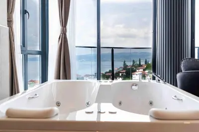 a bath tub in a room with a large window at Sapanora Hotel in Sapanca