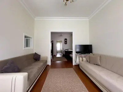 a living room with a couch and a television at Garden House Heybeliada in Adalar