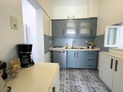 a kitchen with blue cabinets and a sink at Garden House Heybeliada in Adalar