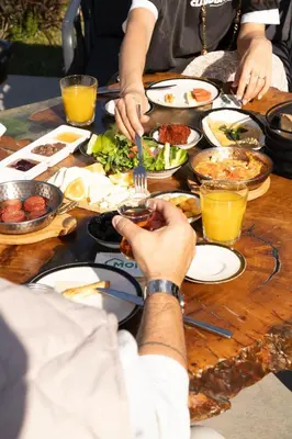 a group of people sitting at a table eating food at Monk Living Space in Kocaeli