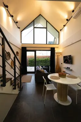 a living room with a large window and a table at Monk Living Space in Kocaeli