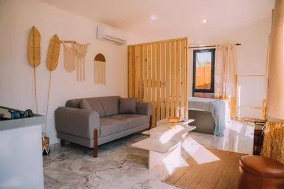 a living room with a couch and a chair at Monk Living Space in Kocaeli