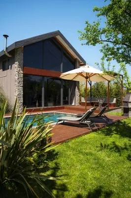 a house with a swimming pool and an umbrella at Monk Living Space in Kocaeli
