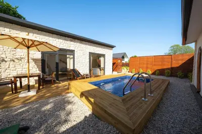 a backyard with a pool and a table and an umbrella at Monk Living Space in Kocaeli
