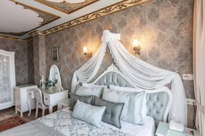 a bedroom with a white bed with a canopy at Romantic Hotel Istanbul in Istanbul