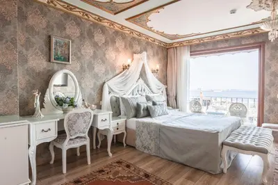 a bedroom with a bed and a desk and a mirror at Romantic Hotel Istanbul in Istanbul