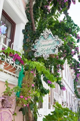 a sign on the side of a building with flowers at Romantic Hotel Istanbul in Istanbul