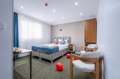 a hotel room with a bed and a chair at Atakent Suite Hotel in Istanbul