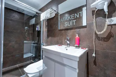 a bathroom with a white sink and a toilet at Atakent Suite Hotel in Istanbul