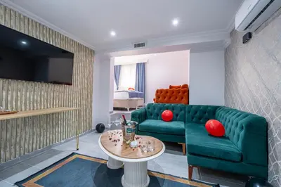 a living room with a green couch and a table at Atakent Suite Hotel in Istanbul