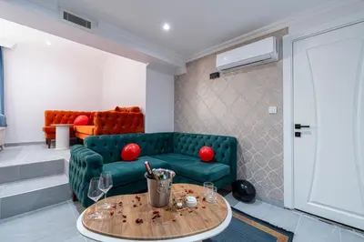 a living room with a green couch and a table at Atakent Suite Hotel in Istanbul