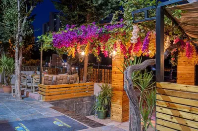 a restaurant with flowers hanging from a fence at Atakent Suite Hotel in Istanbul