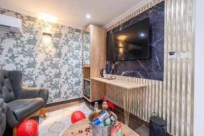 a living room with a tv on a wall at Atakent Suite Hotel in Istanbul