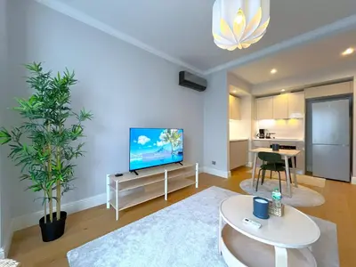 a living room with a television and a table at Taksim360 Residences in Istanbul