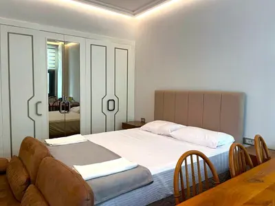 a bedroom with a bed with a table and a mirror at Taksim360 Residences in Istanbul