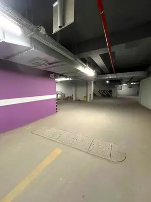 an empty parking garage with a drain in the floor at Taksim360 Residences in Istanbul