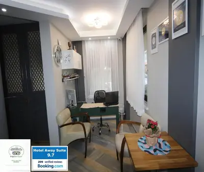 a room with a desk and a table with chairs at Hotel Taksim Home in Istanbul