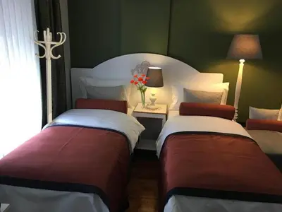 two beds in a hotel room with a room with two at Hotel Taksim Home in Istanbul