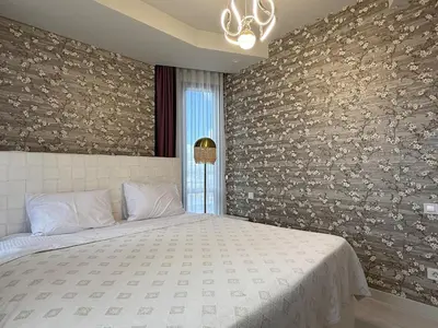a bedroom with a large bed and a stone wall at new luxury comfortable apartment in Istanbul
