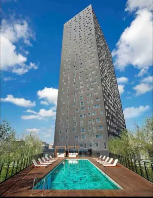 a building with a swimming pool in front of a building at new luxury comfortable apartment in Istanbul