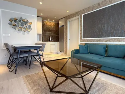 a living room with a blue couch and a table at new luxury comfortable apartment in Istanbul