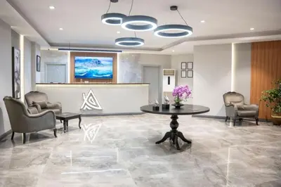a lobby with a table and chairs and a counter at Altınova Hotel Sakarya in Serdivan