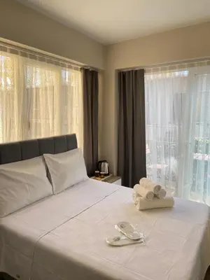 a bedroom with a bed with two towels on it at Büyükada Çarşı Pansiyon in Adalar