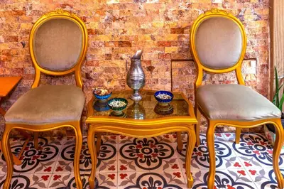 two chairs and a table with a vase on it at Walnut Shell Hotel in Istanbul