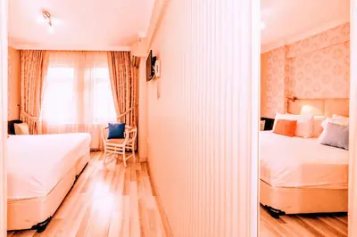 a bedroom with two beds and a window at Walnut Shell Hotel in Istanbul